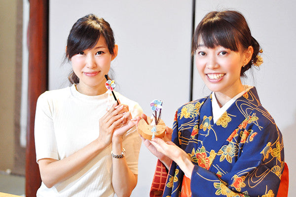 つまみ細工体験でできあがった作品を持つ参加者 京都 おはりばこ